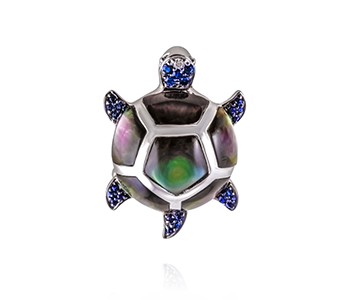 Turtle, paua shell, sapphire, diamond, white gold everywhere, apart from the tail,leg and part of the head section with the blue stones, which are in black